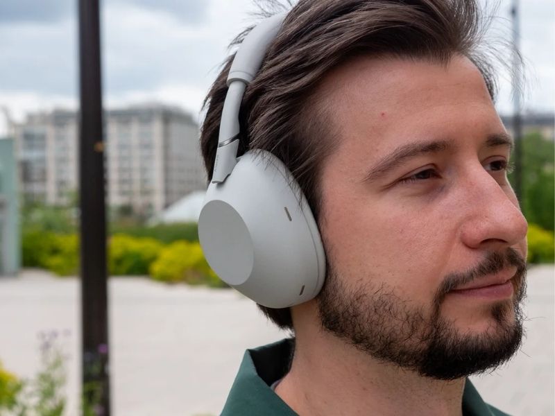 Commuter wearing Sony WH-1000XM6 noise-cancelling headphones outdoors